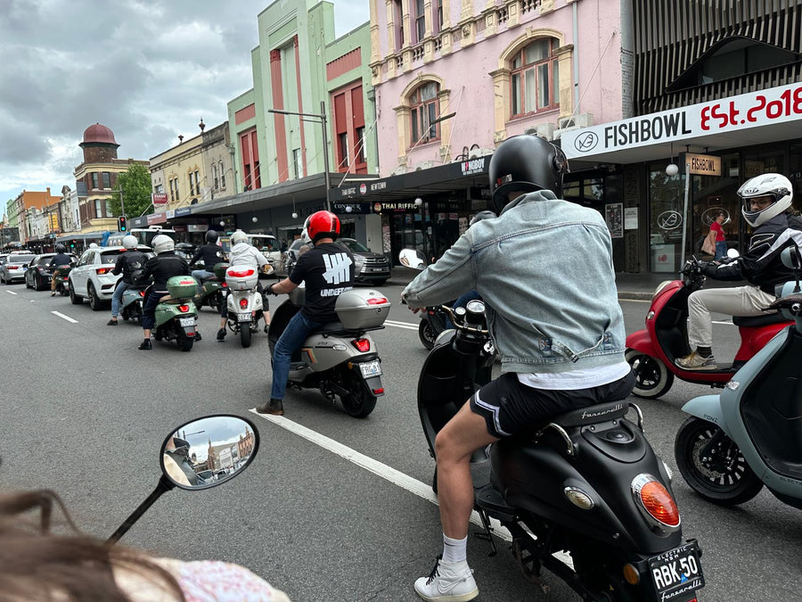 FONZ community riders on electric scooters riding through Sydney