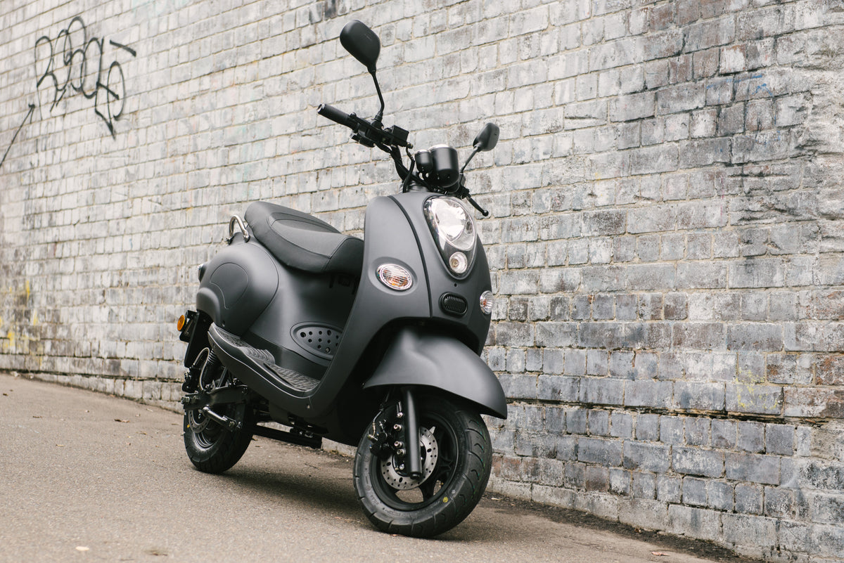 Original Fonzarelli S1 electric scooter in matte grey against a brick wall