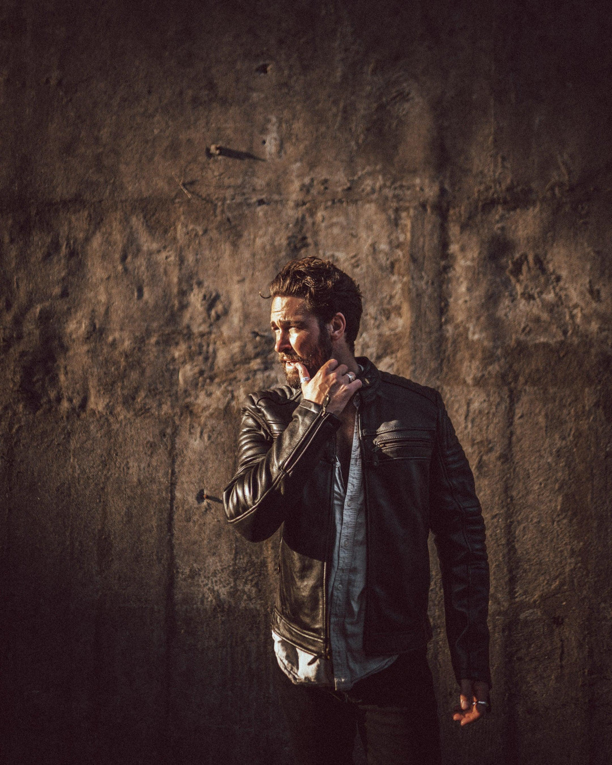 Merla Moto Wakefield men's leather motorcycle jacket, lifestyle shot against a stone wall